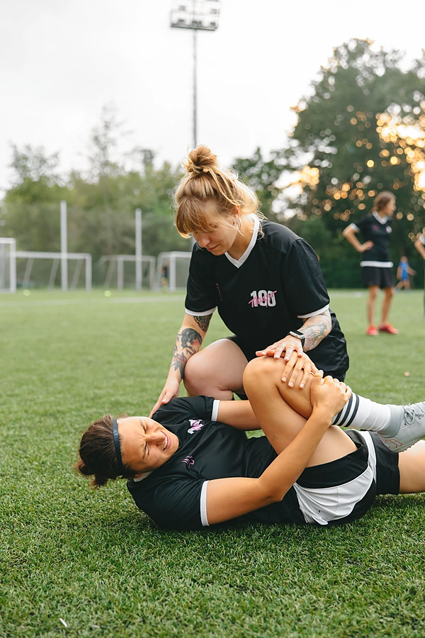 football-player-holding-knee-teammate-kneeling